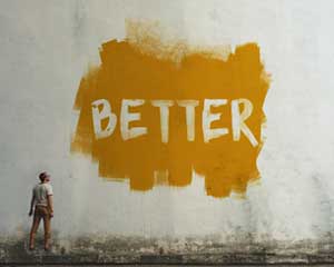 Man looking at wall with "Better" painted on it