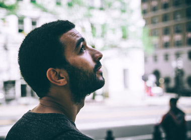 Man in city looking up