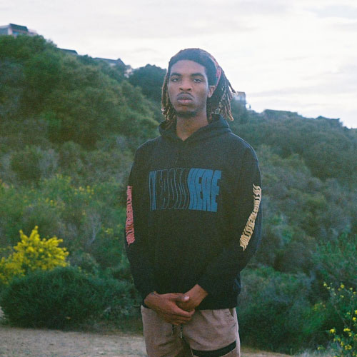 Daniel standing with nature in background