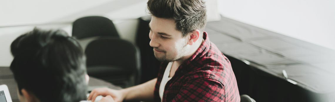 Two men looking at laptop