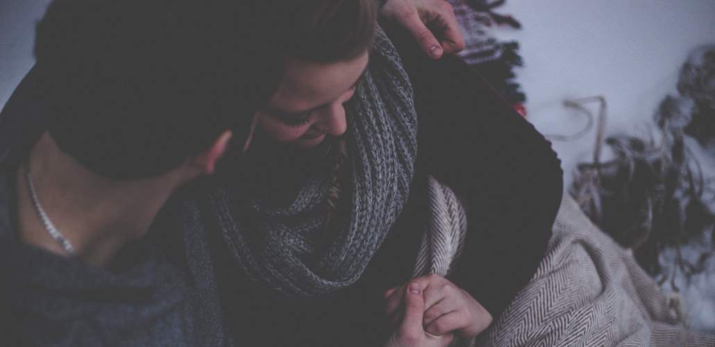 Couple sitting together holding hands