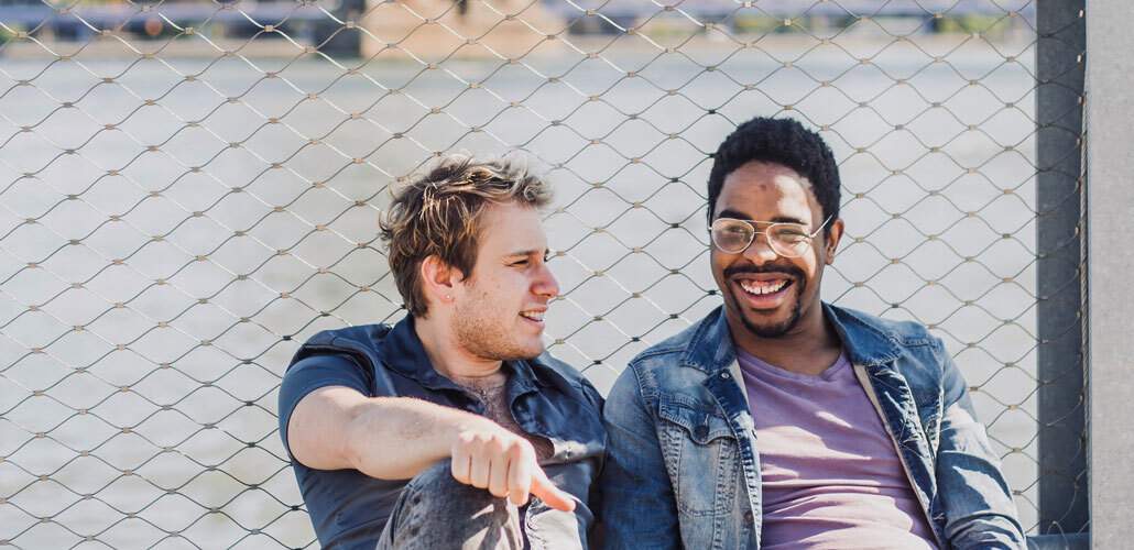 Men Laughing on Fence Big