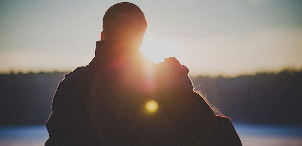 Depressed man with partner looking at sunset