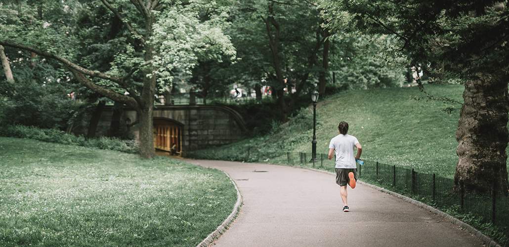 Man running along a path in the park